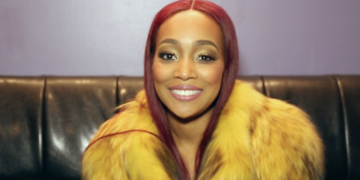 R&B singer Monica smiles backstage at her Baltimore show after discussing her "Code Red" album.