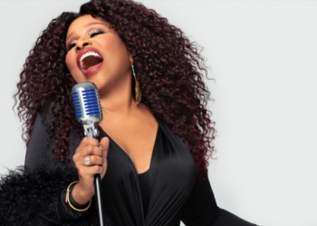 A photo of singer Chaka Khan singing into a microphone