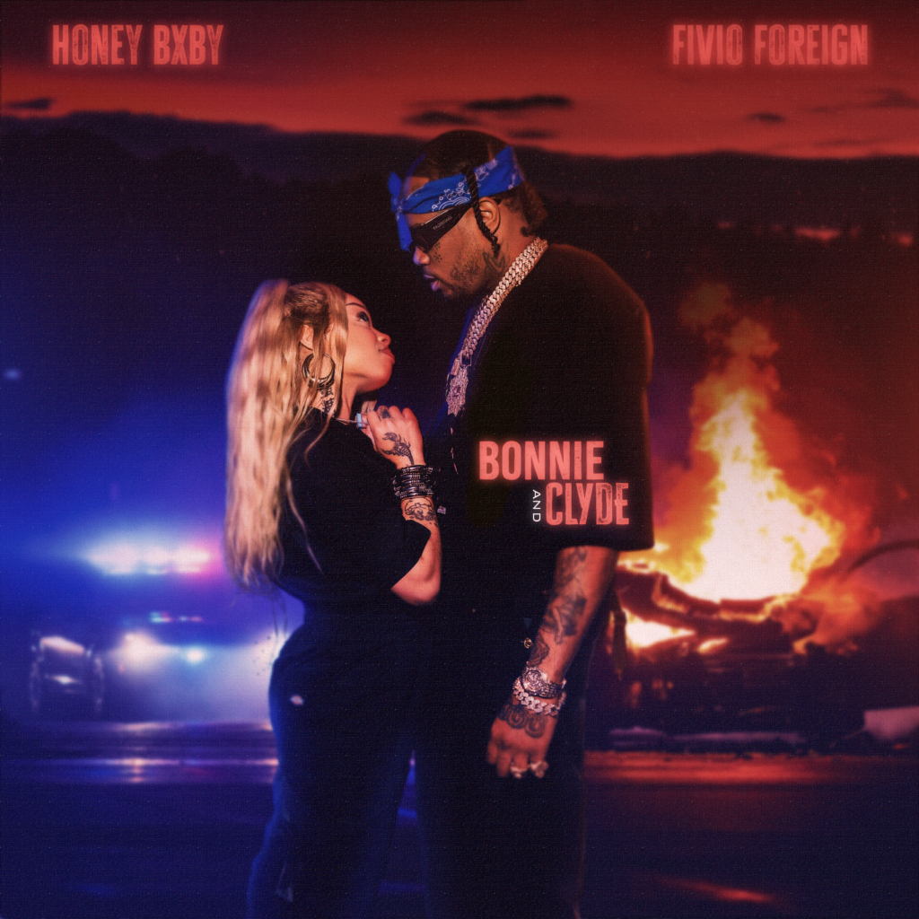 Promotional cover image for the song "Bonnie & Clyde" by artists Honey Bxby and Fivio Foreign. The image features both artists standing close together with a fiery explosion and overturned cars in the background. Both artists are dressed in stylish, urban outfits. Honey Bxby is holding a microphone while Fivio Foreign has several chains around his neck. The title "Bonnie & Clyde" is prominently displayed at the top in bold, stylized text.