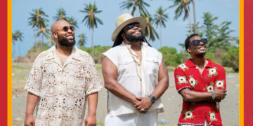 Promotional image featuring Louis York and Gramps Morgan. The three musicians stand together outdoors, smiling under a clear sky, with palms and tropical scenery in the background. Text on the image reads: "LOUIS YORK GRAMPS MORGAN - HAVE A LITTLE LIGHT.