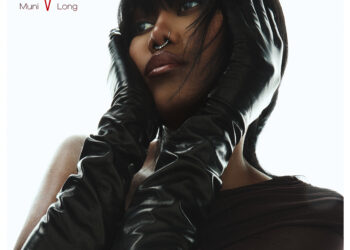 Muni Long's 'Revenge' album cover featuring a close-up of her wearing long black gloves and looking confidently to the side.