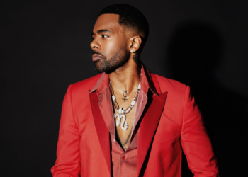 A photo of R&B singer in a red blazer
