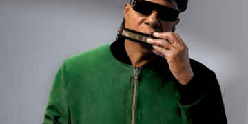 A photo of Stevie Wonder playing the harmonica