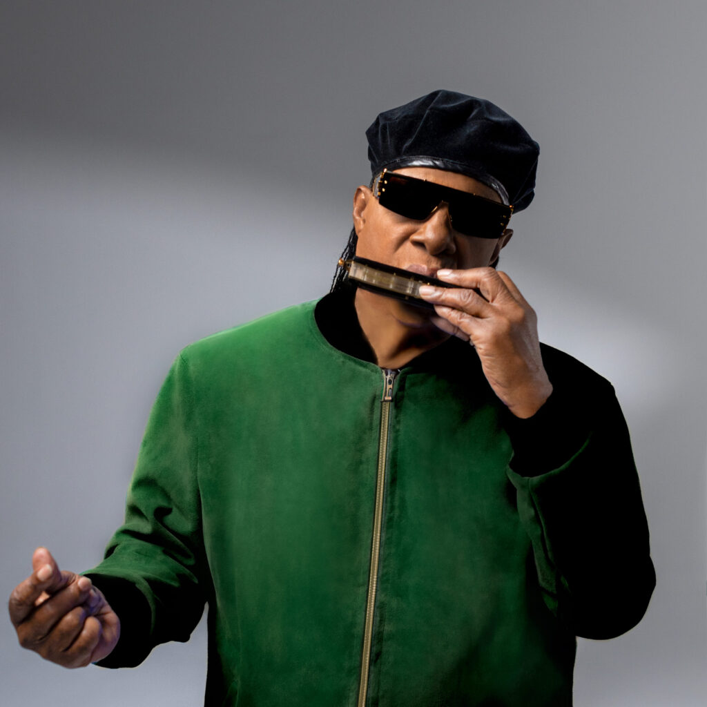 A photo of Stevie Wonder playing the harmonica