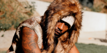 R&B singer Phabo pictured outside wearing a fur coat