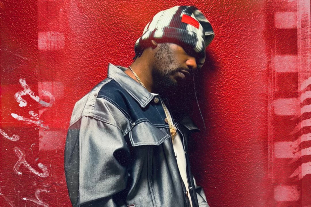 A photo of R&B singer PHABO against a red backdrop