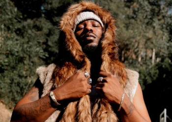 An image of R&B singer Phabo pictured outside wearing a fur coat