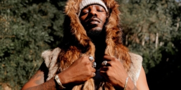 An image of R&B singer Phabo pictured outside wearing a fur coat