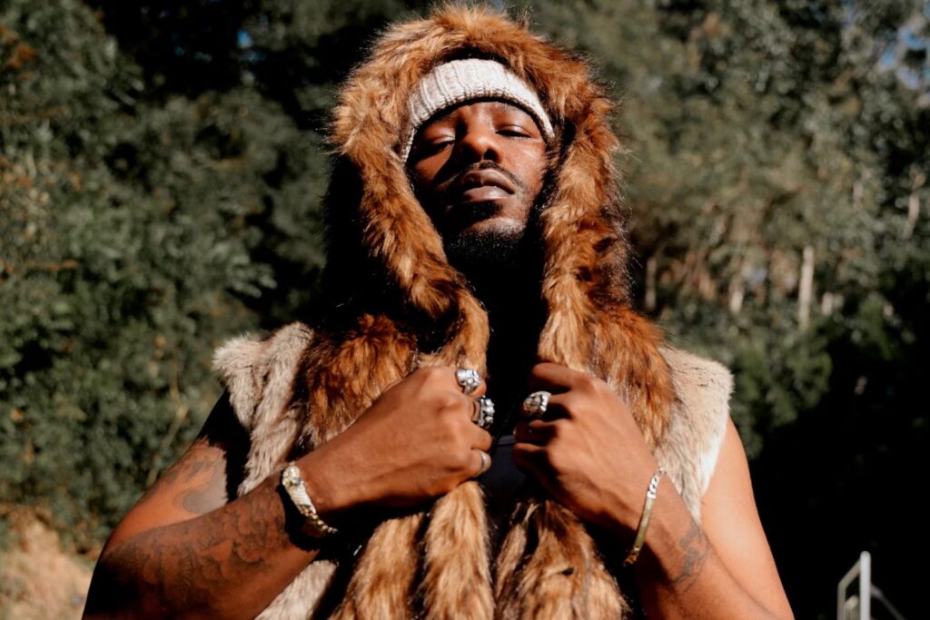 An image of R&B singer Phabo pictured outside wearing a fur coat