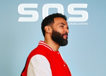 Craig David's SOS single cover: Craig David wearing a red and white varsity jacket, standing against a light blue backdrop