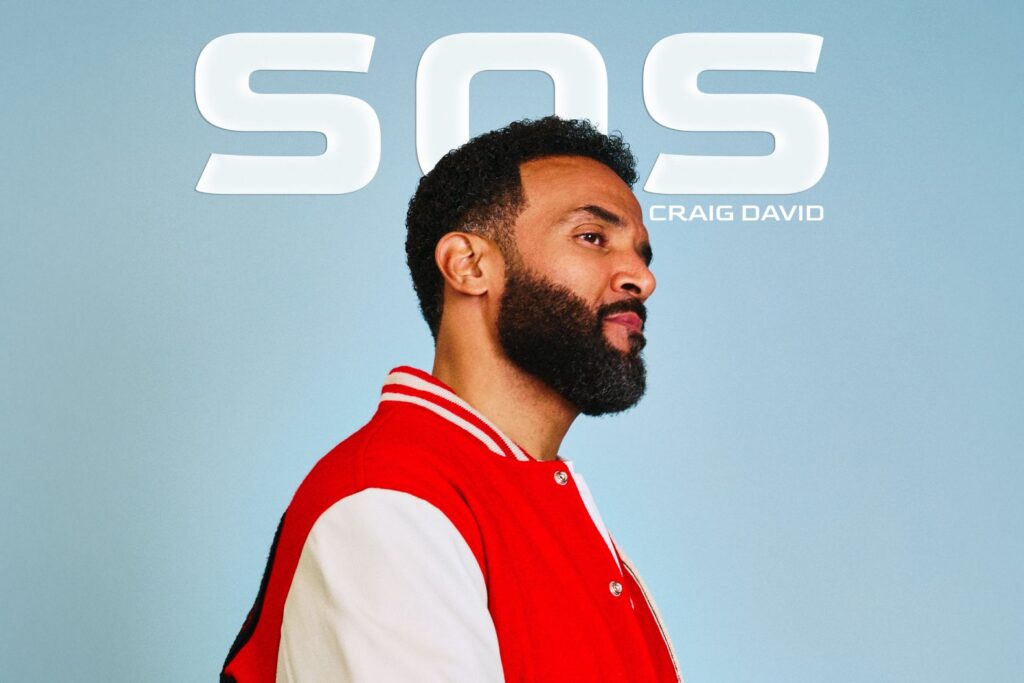 Craig David's SOS single cover: Craig David wearing a red and white varsity jacket, standing against a light blue backdrop