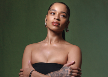 A photo of Ella Mai against a green backdrop