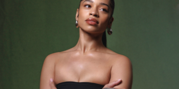 A photo of Ella Mai against a green backdrop