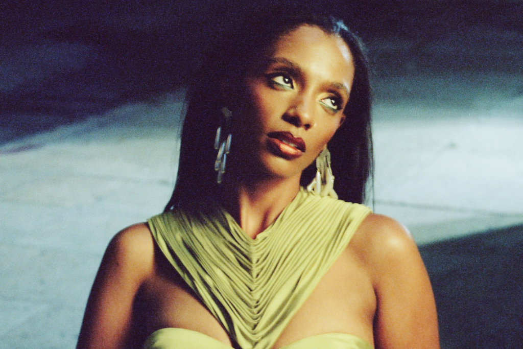 An image of singer Mereba: wearing a green top with earrings