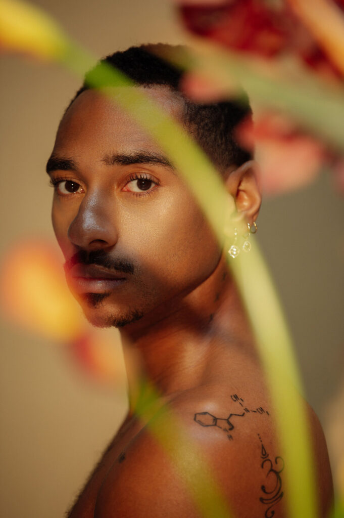 A photo of Durand Bernarr photographed behind a flower