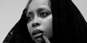 A black and white photo of Erykah Badu
