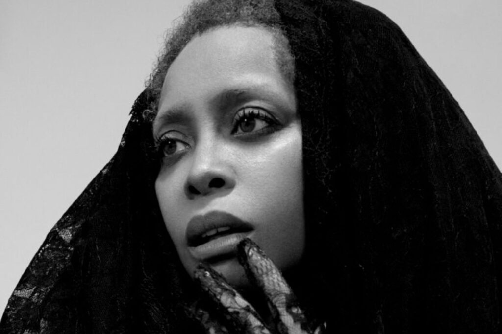A black and white photo of Erykah Badu