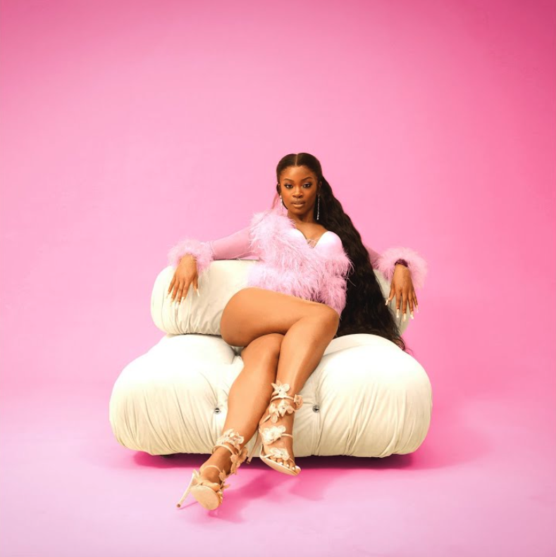 A photo of Ari Lennox against a pink backdrop