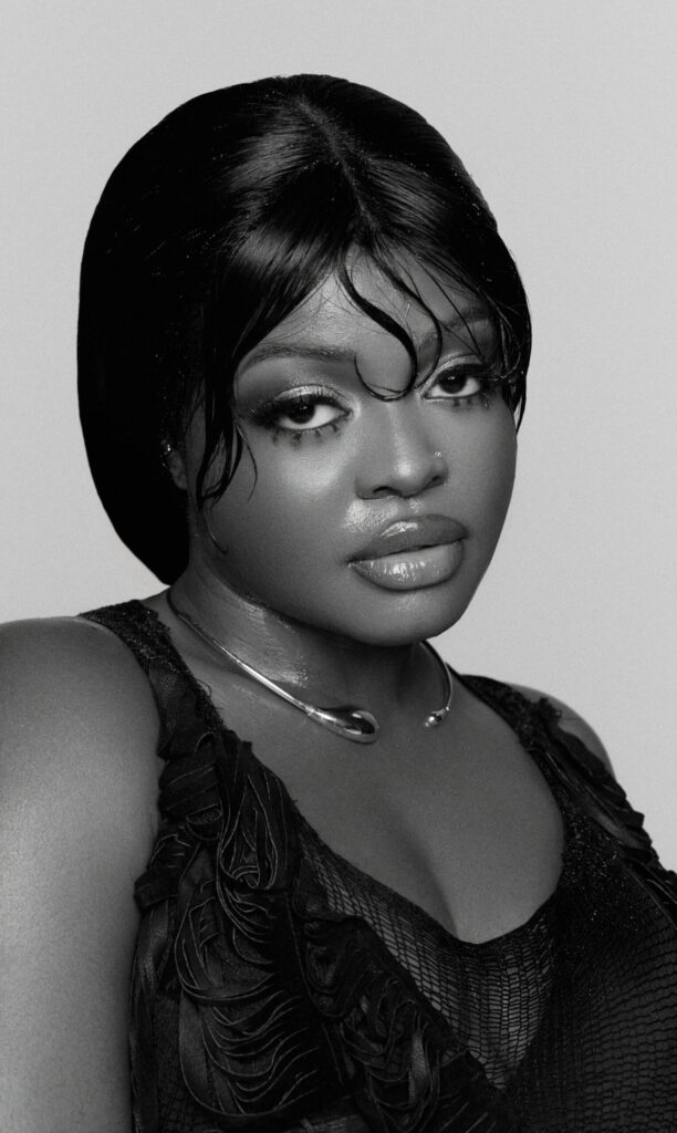 A black and white photo of singer Aqyila