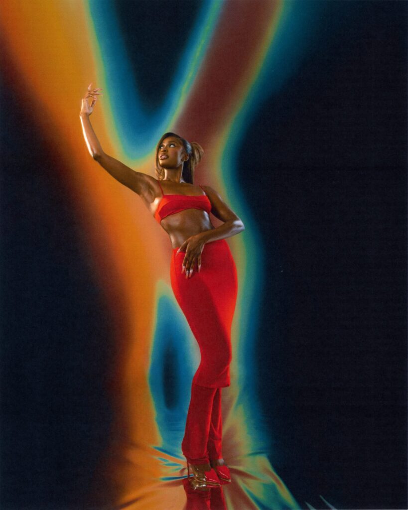 A colorful photo of singer Coco Jones