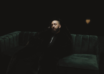 Isaiah Falls sitting on a green couch