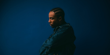 A photo of Ebubé against a blue backdrop