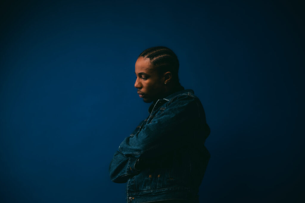 A photo of Ebubé against a blue backdrop