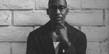 A black and white photo of singer Raphael Saadiq