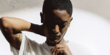 A photo of Syd against a white wall