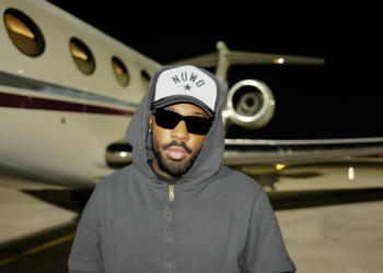 Brent Faiyaz in front of a jet.