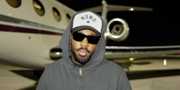Brent Faiyaz in front of a jet.