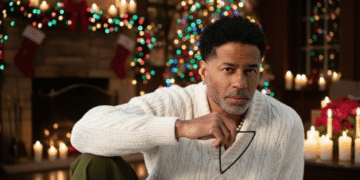 A photo of R&B singer Eric Benet in front of a Christmas tree