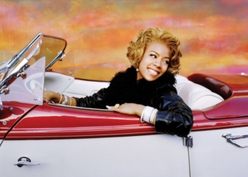 Keyshia Cole in a white and red car