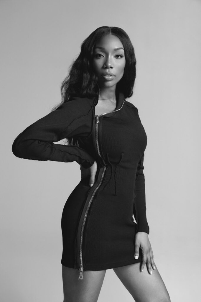 A black and white portrait of music icon Brandy