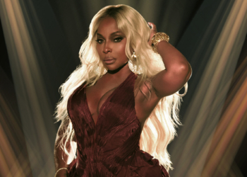 A photo of Mary J. Blige with spotlights
