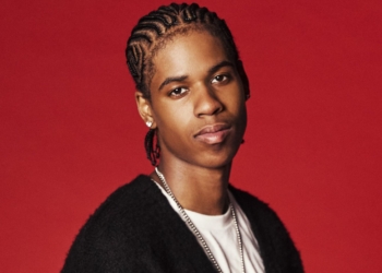 A photo of R&B singer JayDon against a red backdrop