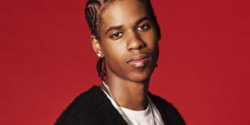 A photo of R&B singer JayDon against a red backdrop