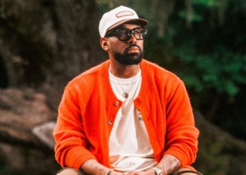 a photo of PJ morton in an orange sweater