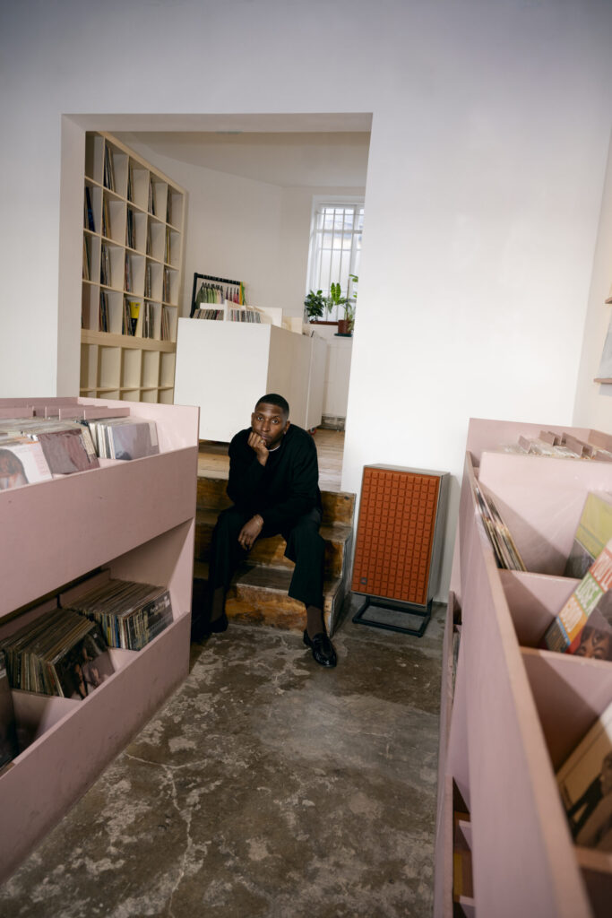 A photo of Samm Henshaw in a record store