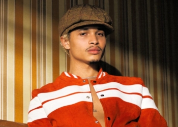 A photo of Destin Conrad leaning against the wall