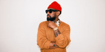 A photo of PJ Morton against a wall