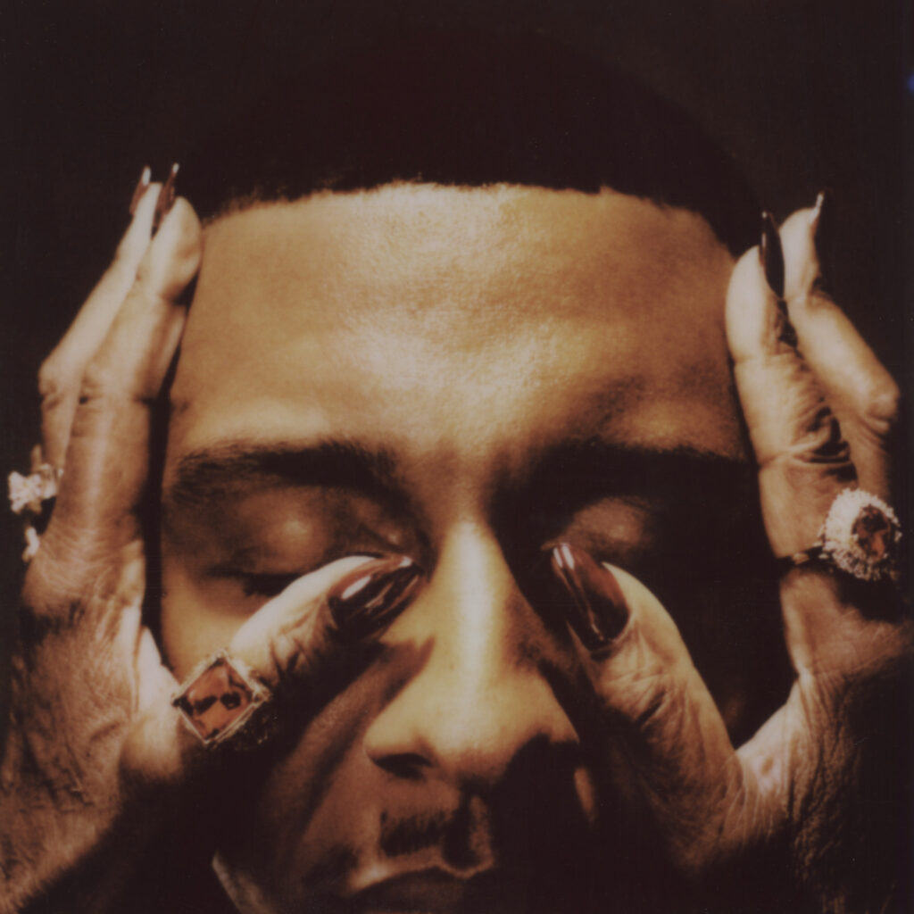 Masego's Fix Your Face album cover: featuring a close-up of his eyes closed with an elder woman's hands offering comfort